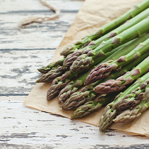 A plate of asparagus, which is a food that can cause flatulence.