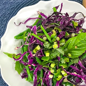 A bowl of green bean salad. This tasty recipe is packed with nutrients and only has 151 calories per serving.